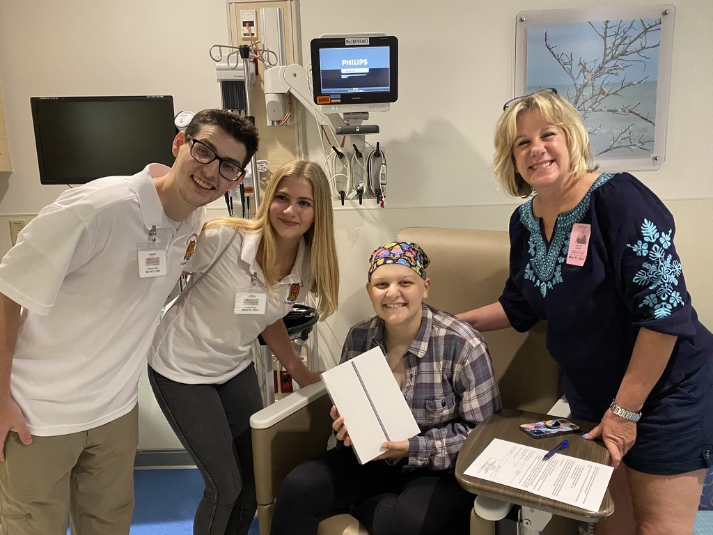 Bryce giving cancer patients a brand-new Apple iPad